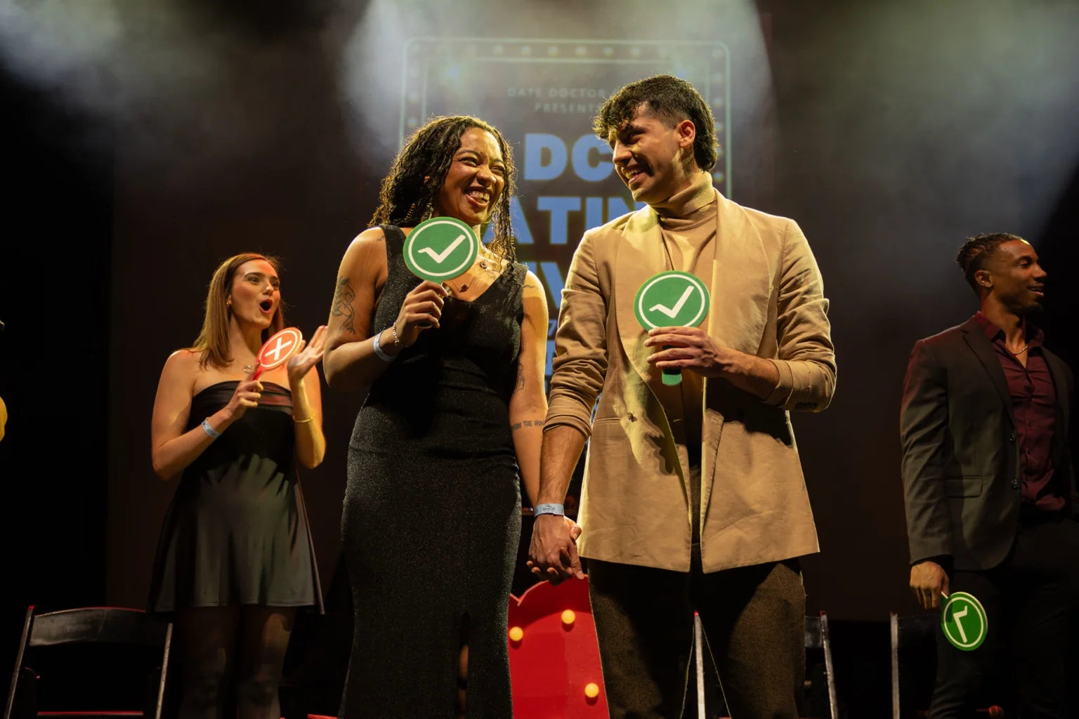 A couple smiling on stage at DC Dating Live